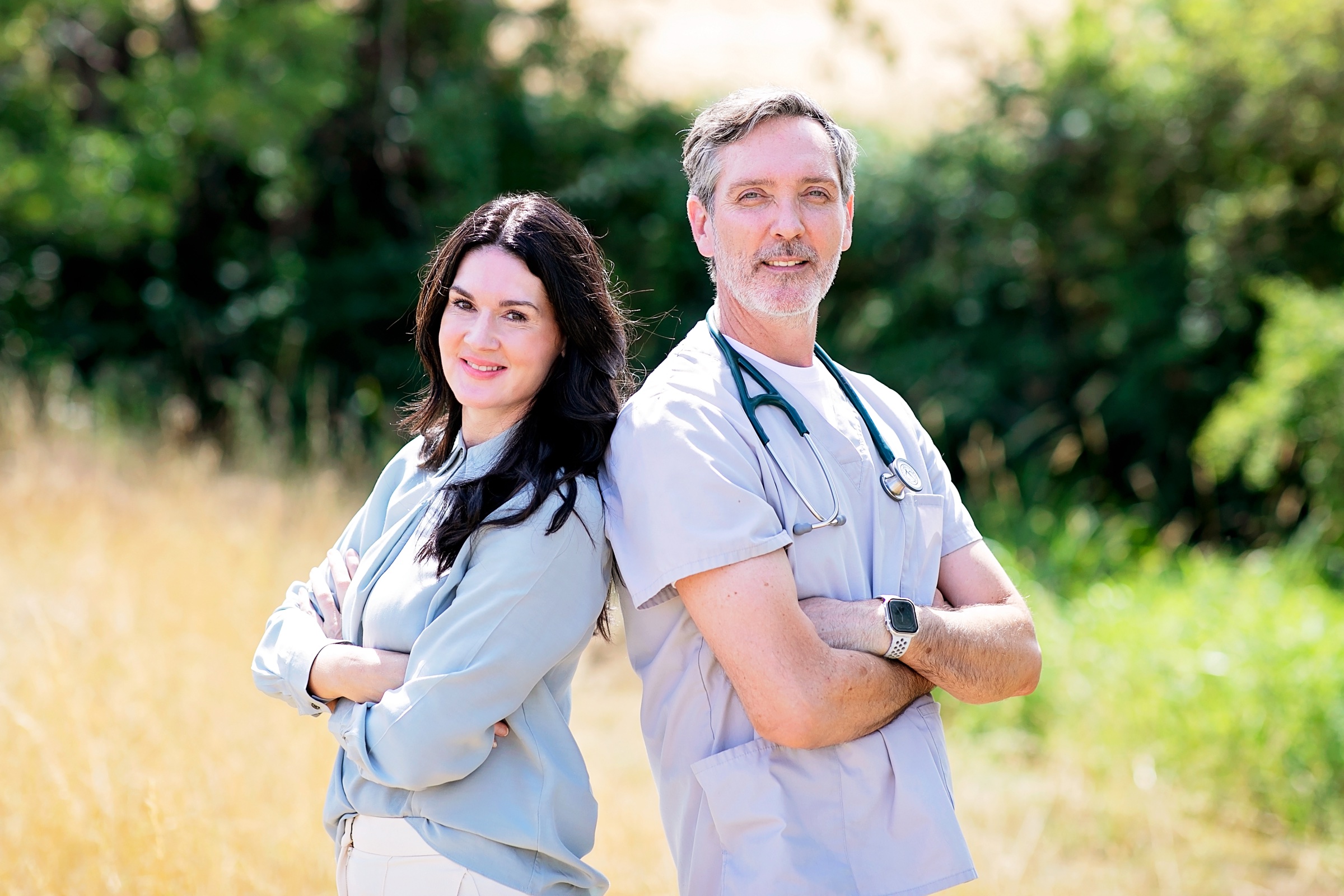Mark and Kellie, the VetYourSelf founders, standing together in veterinary scrubs