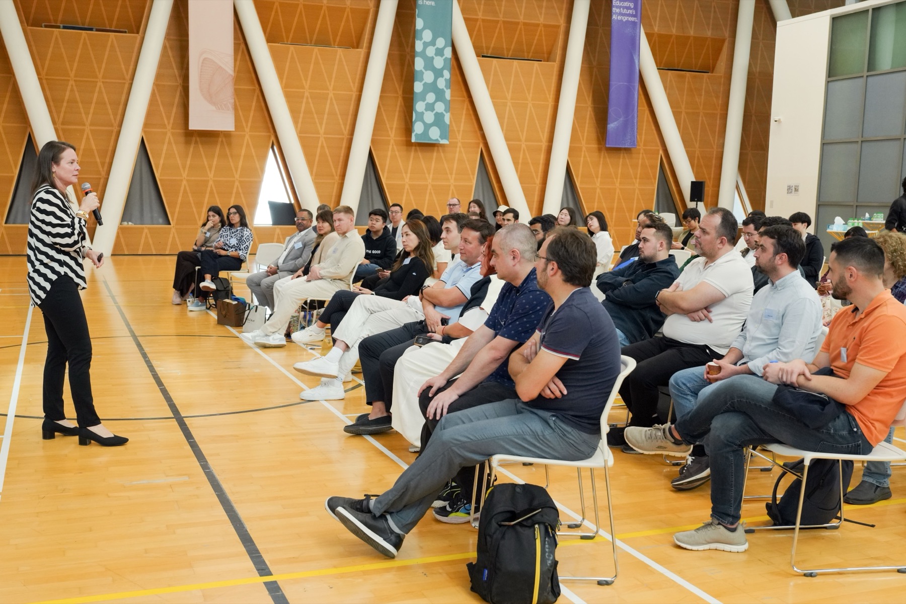 Professionals listening to a speaker at a bright conference event